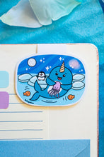Load image into Gallery viewer, A joyful magnetic bookmark featuring a cute narwhal with a big smile, swimming through the ocean. This eco-friendly bookmark has a playful, hand-drawn style, perfect for adding a touch of whimsical charm to your reading! 🦄🌊📖✨