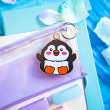 Load image into Gallery viewer, A charming wooden keychain featuring a cute penguin with a cheerful expression, ready to waddle along with you. This eco-friendly keychain has a playful, hand-carved design, perfect for adding a touch of whimsy to your keys or bag! 🐧❄️✨