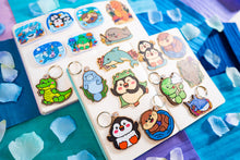 Load image into Gallery viewer, A charming wooden keychain featuring a cute penguin with a cheerful expression, ready to waddle along with you. This eco-friendly keychain has a playful, hand-carved design, perfect for adding a touch of whimsy to your keys or bag! 🐧❄️✨