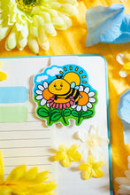 Load image into Gallery viewer, A Spring Bee Magnetic Bookmark is a charming accessory designed to mark your place in books, planners, or journals. Featuring a delightful bee illustration, this bookmark adds a touch of whimsy to your reading experience. Its strong magnets securely grip the pages, ensuring you can easily return to your spot.