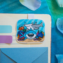Load image into Gallery viewer, A vibrant magnetic bookmark featuring a group of sharks swimming gracefully through a colorful coral reef. This eco-friendly bookmark has a stunning, hand-drawn design, perfect for adding an oceanic touch to your reading! 🦈🌊🐠📖✨