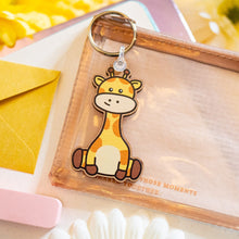 Load image into Gallery viewer, A delightful wooden keychain featuring a cute giraffe with a long neck and a friendly smile. This eco-friendly keychain has a charming, hand-carved design, perfect for adding a touch of jungle-inspired fun to your keys or bag! 🦒🌿✨