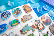 Load image into Gallery viewer,  A charming bamboo sticker featuring a regal seahorse adorned with a tiny crown, floating gracefully in the ocean. This eco-friendly sticker has a whimsical, hand-drawn style, perfect for decorating laptops, water bottles, and journals! 👑🐉✨