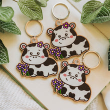 Load image into Gallery viewer, Belugabee Cow and Flowers Wooden Keychains: Trio of adorable cow and flower keychains with metallic rings. Elevate your accessories with these eco-friendly wooden charms. 🐮🌸🔑 #WoodenKeychain #CowAndFlowers #NatureInspiredAccessories