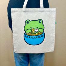 Load image into Gallery viewer, Belugabee Frog Ramen Tote Bag: Whimsical design of a frog slurping noodles from a blue ramen bowl, adding charm to your eco-friendly tote. 🐸🍜🛍️ #FrogRamenToteBag #HumorousDesign #EcoFriendlyFashion