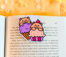 Load image into Gallery viewer, A cute magnetic bookmark featuring two adorable hamster twins enjoying sweet desserts, one with a cupcake and the other with ice cream. This eco-friendly bookmark has a playful, hand-drawn style, perfect for adding a touch of sweetness to your reading! 🐹🍰🍦📖✨