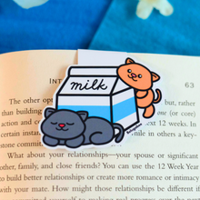 Load image into Gallery viewer, A cute magnetic bookmark featuring adorable kitties peeking out of a milk carton. This eco-friendly bookmark has a playful, hand-drawn style, perfect for adding a touch of sweetness to your reading! 🐱🥛📖