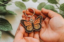 Load image into Gallery viewer, Monarch Butterfly Wooden Keychain - A single wooden keychain adorned with the enchanting beauty of a colorful monarch butterfly. 🦋✨ #ButterflyKeychain #WoodenAccessory #NatureInspired