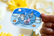 Load image into Gallery viewer, A whimsical glossy sticker featuring a cheerful narwhal swimming through the ocean with its signature spiral tusk. This eco-friendly sticker has a fun, hand-drawn style, perfect for adding a touch of ocean magic to your laptop, water bottle, or notebook! 🦄🌊✨