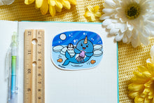 Load image into Gallery viewer, A whimsical glossy sticker featuring a cheerful narwhal swimming through the ocean with its signature spiral tusk. This eco-friendly sticker has a fun, hand-drawn style, perfect for adding a touch of ocean magic to your laptop, water bottle, or notebook! 🦄🌊✨