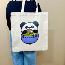 Load image into Gallery viewer, The Panda Ramen Tote Bag is a charming accessory that combines the cuteness of pandas with the allure of ramen. Crafted from eco-friendly materials, this tote is both functional and stylish