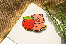 Load image into Gallery viewer, A cute pig happily hugging a big, juicy strawberry, with a soft pastel background. This eco-friendly bamboo sticker has an adorable, hand-drawn style, perfect for decorating laptops, water bottles, and notebooks. 🍓🐷💖
