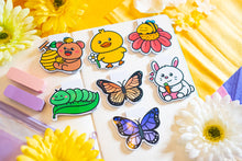 Load image into Gallery viewer, The Special Spring Magnetic Bookmark Set is a collection of five charming bookmarks, each featuring unique spring-themed designs. These bookmarks are double-sided, with a protective laminate on the front that provides a glossy finish. Each bookmark measures approximately 2.4 inches on its longest side and contains a strong rectangular magnet inside to securely hold your page without causing damage. Please note that colors may vary slightly from the pictures due to lighting and other factors. This set includ