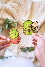 Load image into Gallery viewer, An eco-friendly bamboo sticker featuring a turtle with a strawberry-patterned shell.