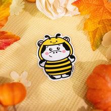 Load image into Gallery viewer, A cute sticker featuring a cow dressed in a bee costume. The cow has a cheerful expression, wearing yellow and black stripes, tiny wings, and a pair of antennae with small round tips. The design is cartoonish and playful, with the cow's spots and hooves adding to its charm. Perfect for adding a whimsical touch to water bottles, laptops, or notebooks.