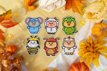 Load image into Gallery viewer, A cute sticker featuring a cow dressed in a bee costume. The cow has a cheerful expression, wearing yellow and black stripes, tiny wings, and a pair of antennae with small round tips. The design is cartoonish and playful, with the cow's spots and hooves adding to its charm. Perfect for adding a whimsical touch to water bottles, laptops, or notebooks.