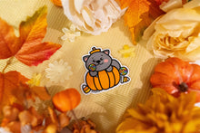Load image into Gallery viewer, A cute black cat sitting beside a pumpkin, with colorful candies scattered around it. The cat has bright, expressive eyes and a playful pose, creating a fun, spooky vibe perfect for Halloween