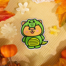 Load image into Gallery viewer, Sticker of a playful cat dressed in a green crocodile costume, complete with scaly details and a fun, whimsical design, perfect for adding a quirky touch to your collection.