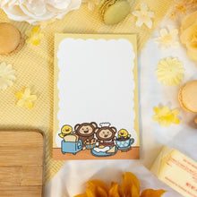 Load image into Gallery viewer, A delightful memo pad featuring a cute monkey enjoying breakfast at a cozy café. With playful illustrations and vibrant colors, this memo pad adds a fun touch to your desk for jotting down notes or reminders. 🍌🍳☕🐒