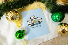 Load image into Gallery viewer, A delightful set of holiday greeting cards featuring whimsical, festive designs. Each card showcases unique artwork, including a cheerful snowman with a cozy scarf, a Christmas tree adorned with colorful ornaments, a playful reindeer with twinkling lights tangled in its antlers, and a warm fireplace scene with stockings hung with care. The cards are accented with gold foil details, vibrant colors, and charming holiday-themed illustrations, perfect for spreading joy and festive cheer to family and friends.