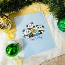 Load image into Gallery viewer, A delightful set of holiday greeting cards featuring whimsical, festive designs. Each card showcases unique artwork, including a cheerful snowman with a cozy scarf, a Christmas tree adorned with colorful ornaments, a playful reindeer with twinkling lights tangled in its antlers, and a warm fireplace scene with stockings hung with care. The cards are accented with gold foil details, vibrant colors, and charming holiday-themed illustrations, perfect for spreading joy and festive cheer to family and friends.