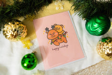 Load image into Gallery viewer, A delightful set of holiday greeting cards featuring whimsical, festive designs. Each card showcases unique artwork, including a cheerful snowman with a cozy scarf, a Christmas tree adorned with colorful ornaments, a playful reindeer with twinkling lights tangled in its antlers, and a warm fireplace scene with stockings hung with care. The cards are accented with gold foil details, vibrant colors, and charming holiday-themed illustrations, perfect for spreading joy and festive cheer to family and friends.