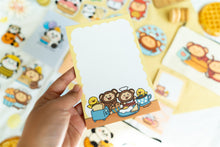 Load image into Gallery viewer, A delightful memo pad featuring a cute monkey enjoying breakfast at a cozy café. With playful illustrations and vibrant colors, this memo pad adds a fun touch to your desk for jotting down notes or reminders. 🍌🍳☕🐒