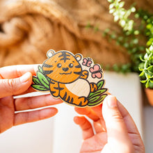 Load image into Gallery viewer, A baby tiger resting peacefully in a lush green meadow, surrounded by colorful butterflies gently fluttering around it.