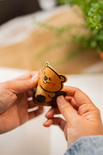 Load image into Gallery viewer, Bamboo Sticker of Beaver being bent to show durability and flexibility of bamboo stickers