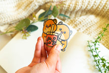 Load image into Gallery viewer, Belugabee Bamboo Sticker: Adorable duo of hamsters holding boba cups, crafted on eco-friendly bamboo, showcasing flexibility when bent. Elevate your style with this charming 3x3-inch sticker. 🐹🥤🌿 #BambooSticker #HamsterBobaDesign #CuteDecor
