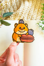 Load image into Gallery viewer, Belugabee Hamster Macaron Bamboo Sticker Alt Text: Cute hamster holding a macaroon with a playful blueberry perched on its head, intricately designed on eco-friendly bamboo. 🐹🍬 #BambooSticker #HamsterMacaronDesign #AdorableDecor