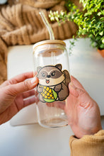 Load image into Gallery viewer, An adorable raccoon with bright, curious eyes, holding a tiny treasure in its paws! This eco-friendly bamboo sticker features soft, earthy tones and a charming design, perfect for adding a touch of woodland whimsy to your water bottle, laptop, or journal. A must-have for raccoon lovers!