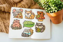 Load image into Gallery viewer, An adorable raccoon with bright, curious eyes, holding a tiny treasure in its paws! This eco-friendly bamboo sticker features soft, earthy tones and a charming design, perfect for adding a touch of woodland whimsy to your water bottle, laptop, or journal. A must-have for raccoon lovers!