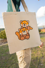 Load image into Gallery viewer, A heartwarming design featuring a loving red panda mom cuddling her adorable baby, surrounded by soft nature-inspired details. Printed on a sturdy, eco-friendly tote bag, perfect for carrying books, groceries, and everyday essentials. A must-have for red panda lovers!