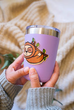 Load image into Gallery viewer, The Sleepy Hanging Sloth Bamboo Sticker is an eco-friendly accessory featuring an adorable illustration of a sloth hanging from a branch, appearing sleepy and content. Crafted from 100% sustainable bamboo, this sticker measures approximately 3x3 inches. It is designed to be fade and weather-resistant, making it suitable for various surfaces such as hydro flasks, journals, and tote bags. The strong 3M water-resistant adhesive ensures durability and longevity. Due to the natural variations in bamboo, each sti
