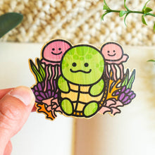 Load image into Gallery viewer, This set includes a green turtle cartoon character with a red tongue sticking out, holding a waffle cone ice cream with a white swirl on top. The adhesive is very strong, so make sure you stick this sticker onto a place where you'd want it for a long time