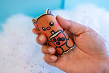 Load image into Gallery viewer, Belugabee Bamboo Sticker: Demonstrating durability and flexibility – Adorable brown bear enjoying chunky boba, bending the sticker to showcase its eco-friendly resilience. Elevate your style with this 3x3-inch sticker. 🐻🍵 #BambooSticker #ChunkyBobaBear #FlexibilityAndDurability