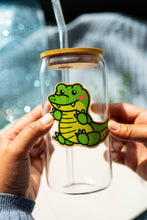 Load image into Gallery viewer, Belugabee Bamboo Sticker: Striking green crocodile design adorning a glass cup, infusing wild charm into your drinkware. Elevate your style with this eco-friendly 3x3-inch bamboo sticker. 🐊🌿 #BambooSticker #GreenCrocodile #GlassCupDecor