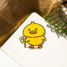 Load image into Gallery viewer, Belugabee Bamboo Sticker: Adorable design of a duck holding a vibrant flower, crafted on eco-friendly bamboo. Elevate your style with this charming 3x3-inch sticker. 🦆🌸 #BambooSticker #DuckAndFlower #CuteDesign