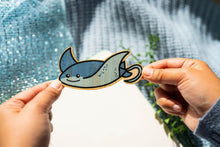 Load image into Gallery viewer, The Stingray Bamboo Sticker is an eco-friendly accessory featuring a charming illustration of a stingray. Crafted from 100% sustainable bamboo, this sticker measures approximately 3x3 inches.