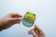 Load image into Gallery viewer, iPhone Case with Frog Ramen Sticker Alt Text: Enhance your iPhone&#39;s aesthetics with this clear case adorned by a whimsical frog enjoying a bowl of ramen. The unique bamboo sticker adds a touch of nature and charm to your device, making a statement in style. 📱🐸🍜 #iPhoneCase #FrogRamenSticker #UniqueDesign
