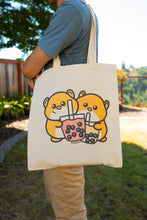 Load image into Gallery viewer, Belugabee Hamster Boba Tote Bag Alt Text: A whimsical tote featuring adorable hamsters enjoying boba drinks. Crafted with care on eco-friendly material, this bag blends cuteness with environmental consciousness. 🐹🥤👜 #BobaTote #CuteEcoFashion #HamsterDesign
