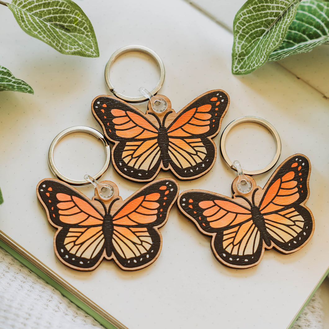 Three Monarch Butterfly Wooden Keychains - A delightful trio of eco-friendly keychains featuring vibrant monarch butterflies. Add a touch of nature-inspired charm to your accessories with these responsibly sourced cherry veneer wood keychains. 🦋🌈 #ButterflyKeychain #WoodenAccessories #NatureLovers