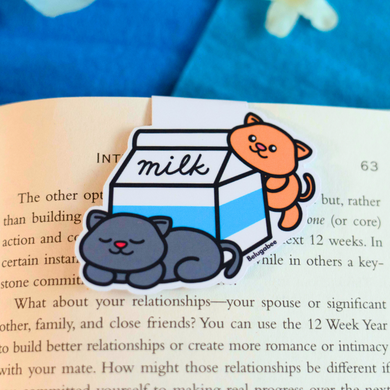 A cute magnetic bookmark featuring adorable kitties peeking out of a milk carton. This eco-friendly bookmark has a playful, hand-drawn style, perfect for adding a touch of sweetness to your reading! 🐱🥛📖