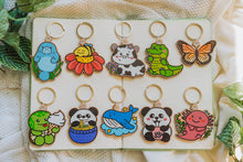 Load image into Gallery viewer, Wooden Keychain Collection - A delightful array of 10 wooden keychain designs featuring various whimsical characters and animals. Perfect for adding a touch of charm to your belongings! 🌈🔑 #WoodenKeychains #AdorableCollection #AccessoryLove
