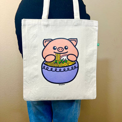 An adorable design featuring a happy pig enjoying a big bowl of ramen, complete with noodles, chopsticks, and tasty toppings! Printed on a durable, eco-friendly tote bag, perfect for carrying books, groceries, and daily essentials. A must-have for foodies and pig lovers alike!