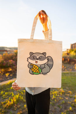 A playful design featuring a mischievous raccoon happily munching on a fresh ear of corn! Printed on a durable, eco-friendly tote bag, perfect for carrying books, groceries, or everyday essentials. A fun and quirky choice for raccoon lovers and foodies!