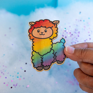 A fluffy alpaca llama with a soft rainbow-colored coat, standing happily with a cheerful expression. This eco-friendly bamboo sticker features a cute, hand-drawn style, perfect for adding a colorful touch to laptops, water bottles, and journals! 🌈🦙✨