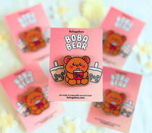 Load image into Gallery viewer, 
A vibrant collection of wooden pins featuring adorable animal designs. The set includes a cheerful turtle with a bright shell, a cute cow with soft spots, a happy ducky with a tiny beak, and a playful frog mid-hop. There’s also a boba bear and boba panda, each holding a cup of boba tea with tapioca pearls, a reading panda (“Pu”) engrossed in a book, and a hungry kitty with a charmingly mischievous expression. Each pin is detailed with colorful accents and natural wood grain, adding personality and whimsy t
