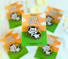 Load image into Gallery viewer, 
A vibrant collection of wooden pins featuring adorable animal designs. The set includes a cheerful turtle with a bright shell, a cute cow with soft spots, a happy ducky with a tiny beak, and a playful frog mid-hop. There’s also a boba bear and boba panda, each holding a cup of boba tea with tapioca pearls, a reading panda (“Pu”) engrossed in a book, and a hungry kitty with a charmingly mischievous expression. Each pin is detailed with colorful accents and natural wood grain, adding personality and whimsy t
